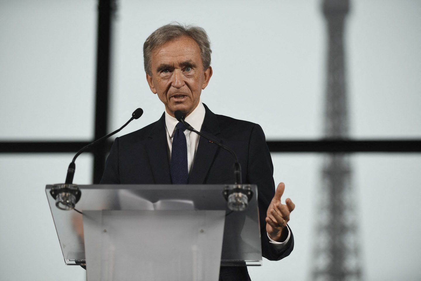 Bernard Arnault standing behind a rostrum