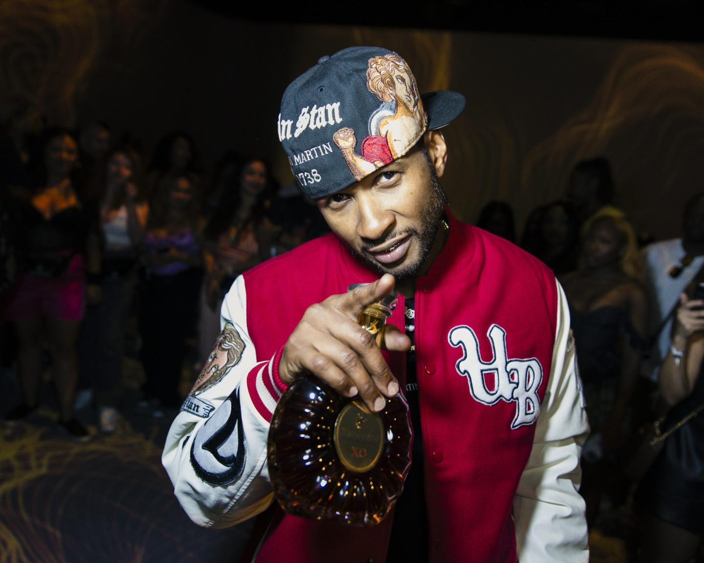 Usher posing with a bottle in his hand