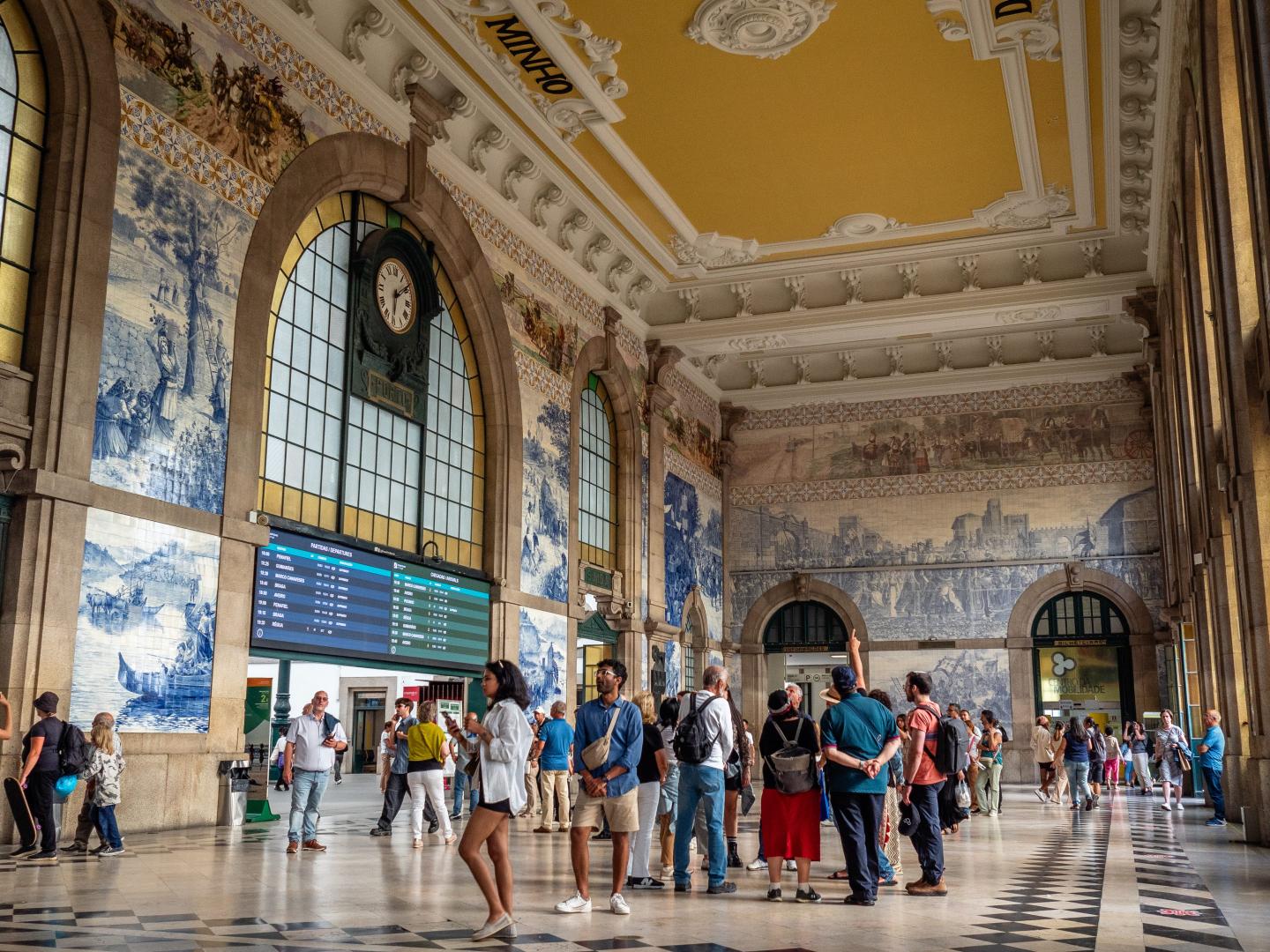 people at a hall in Sao Bento railway station, in Porto, Portugal.