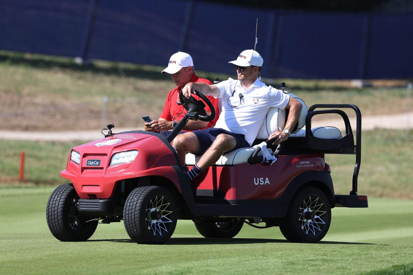 golfers riding a gold cart