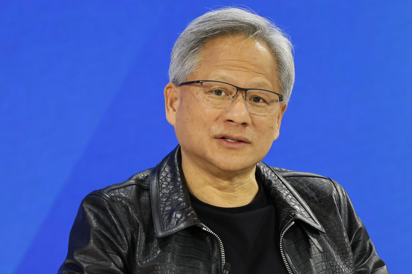 Jensen Huang looks into the camera and during a conference