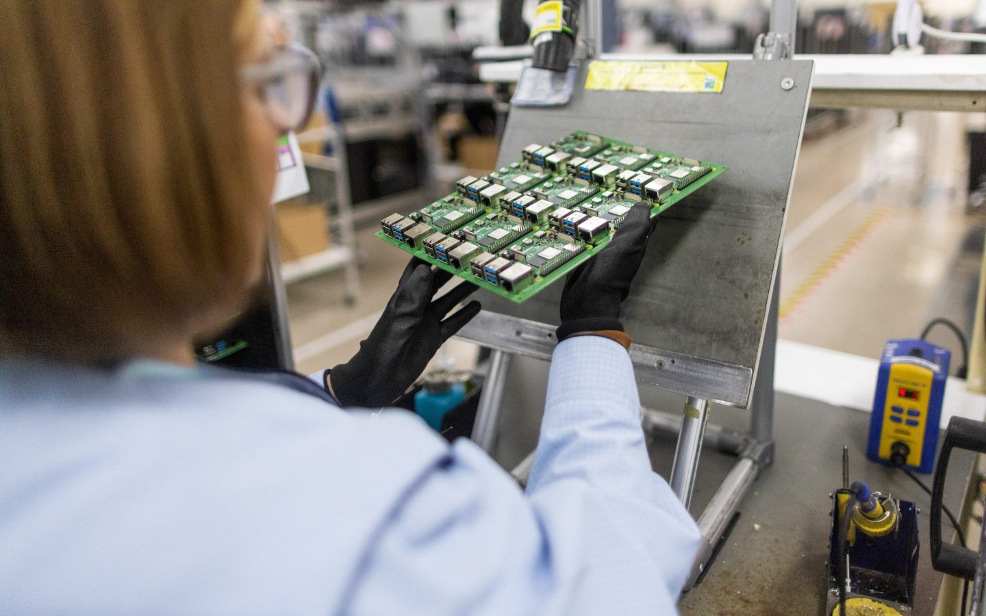 a woman working on a Raspberry Pi PC system