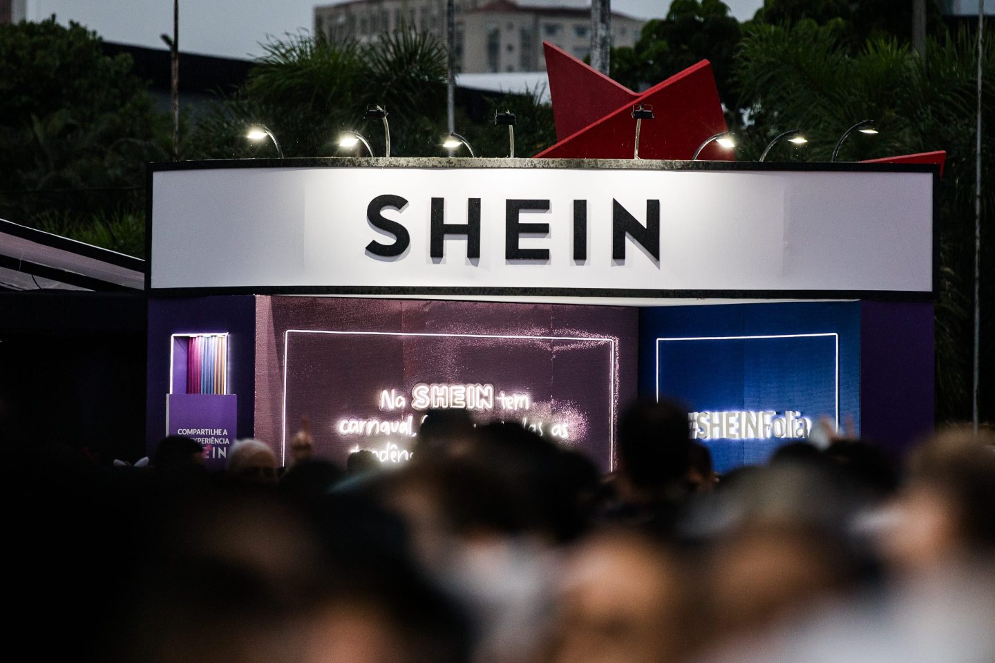 people seen in blur outside a shein store