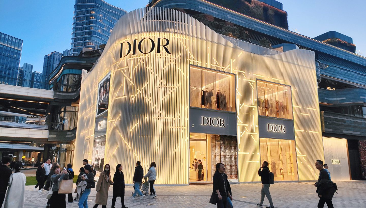 People walking outside a Dior store