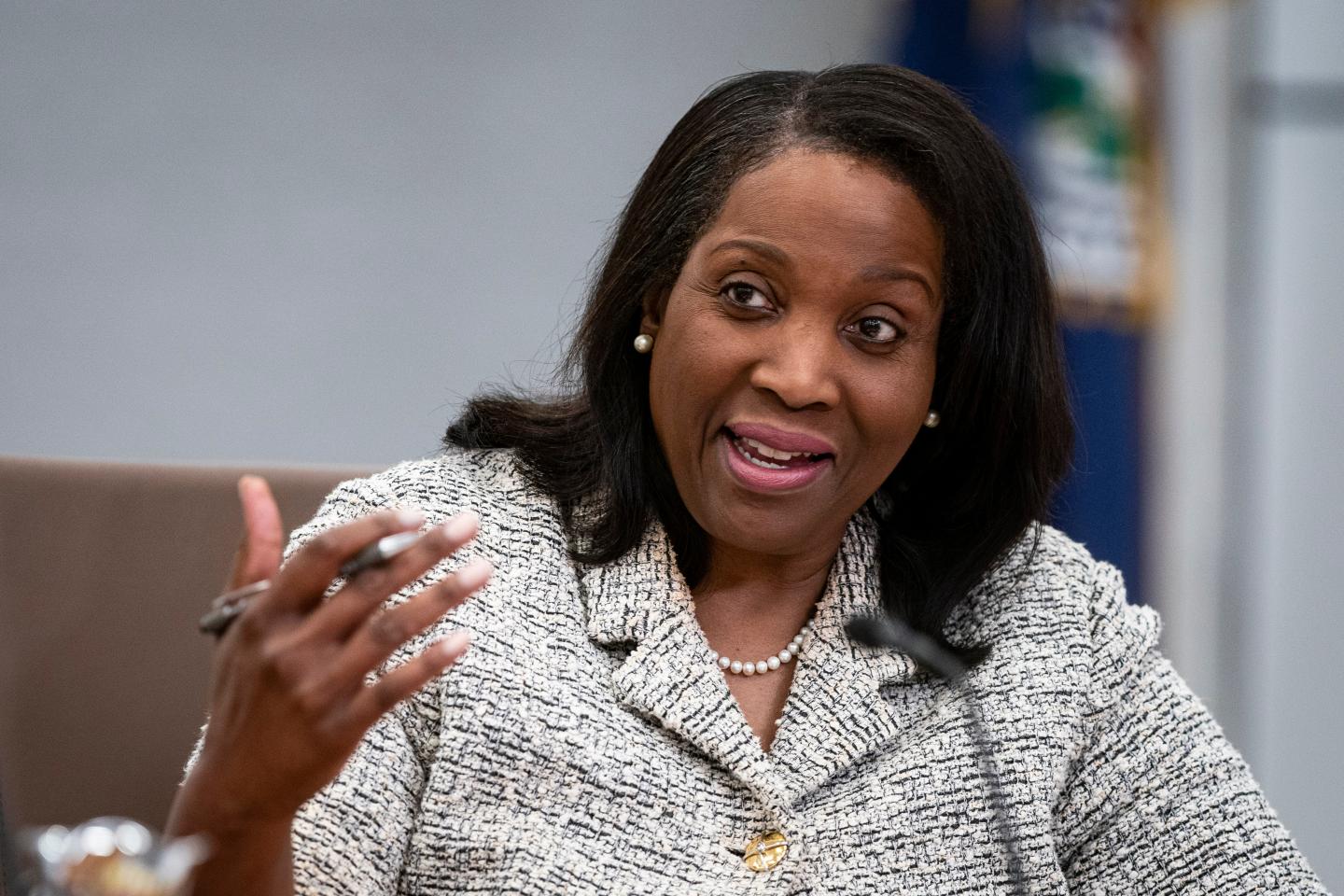 Fed governor LIsa cook gestures with her left hand as she speaks.