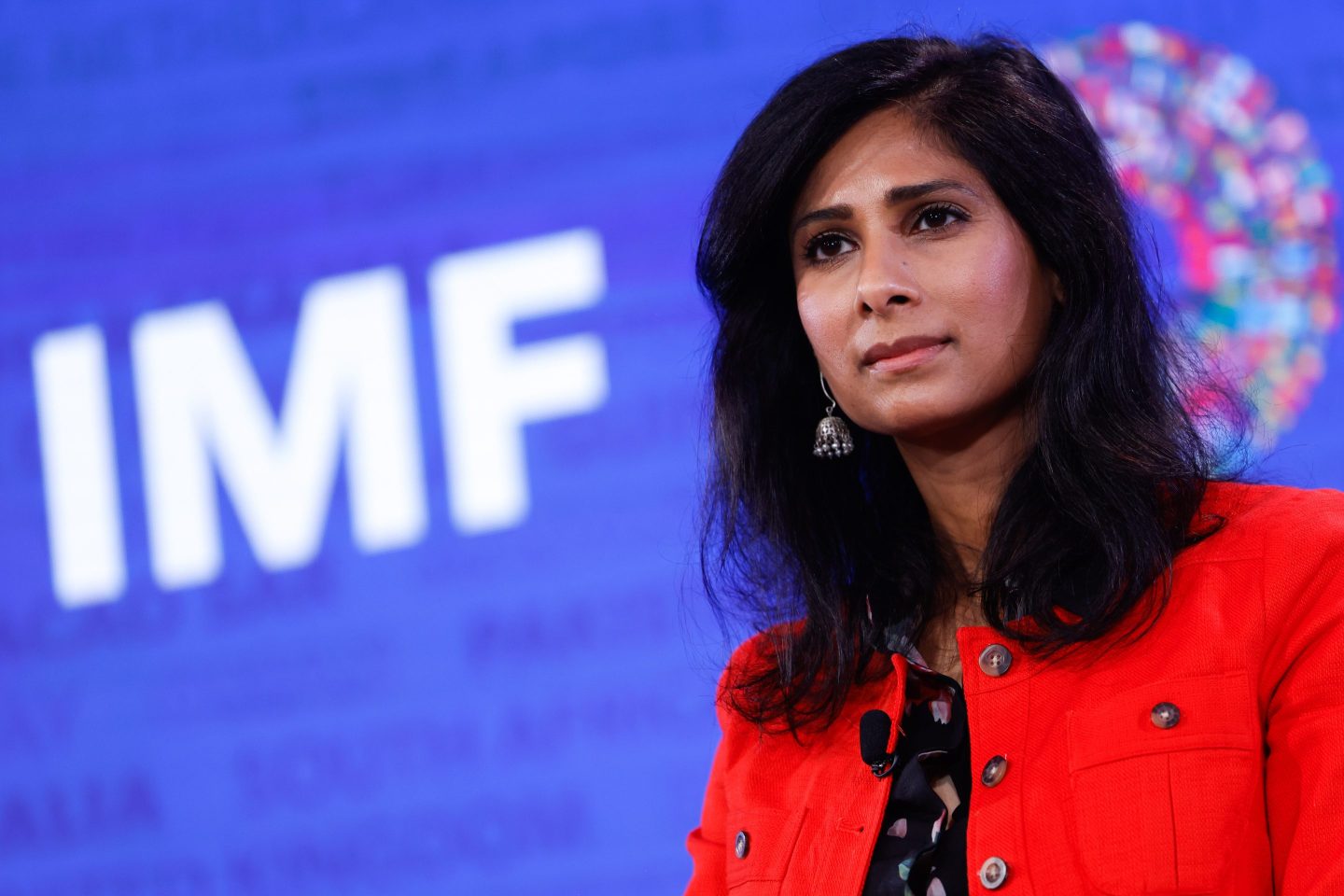 Gita Gopinath sits in front of IMF sign