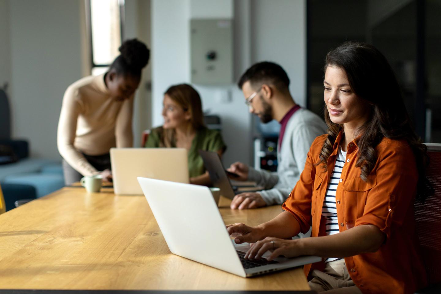 Multiracial group of business people working together in the modern office, discussing about new ideas and brainstorming