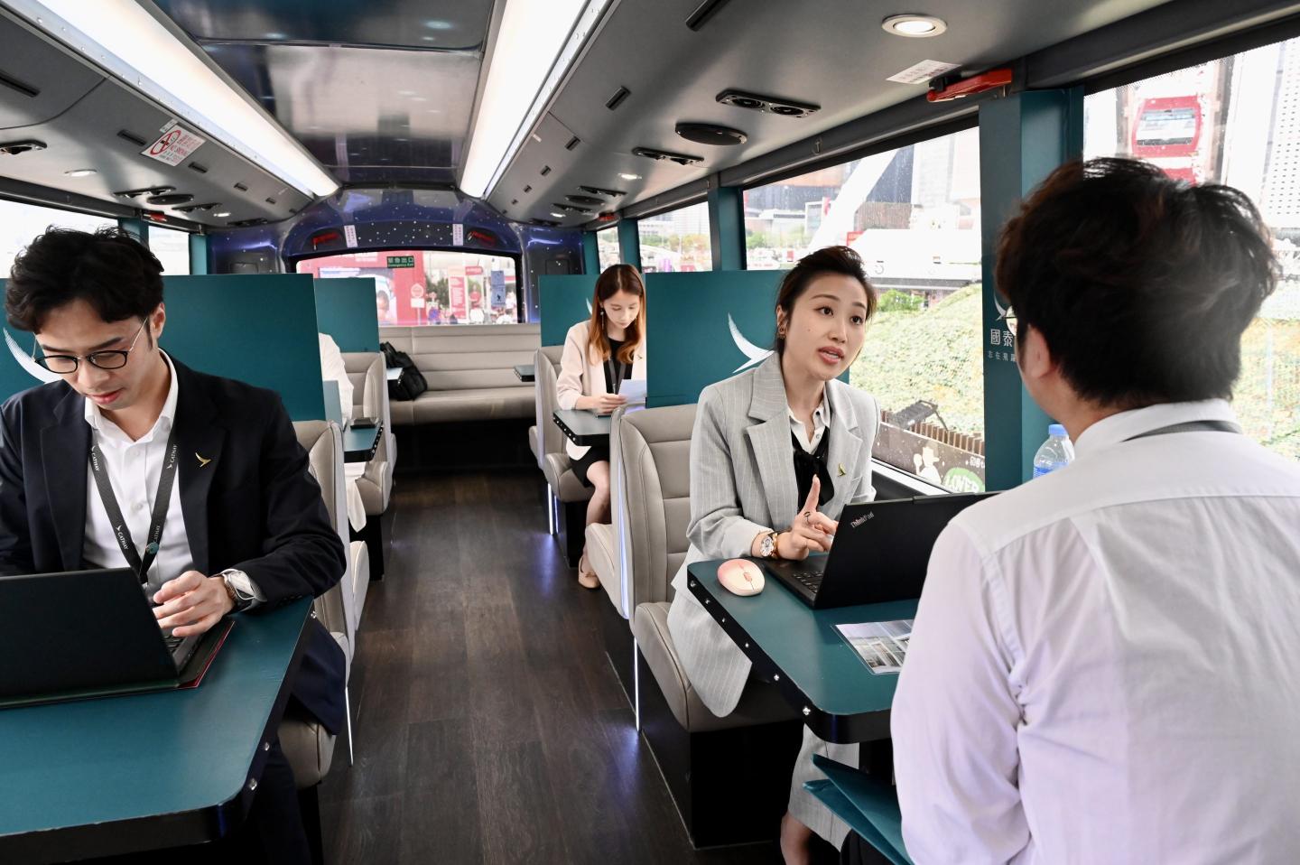 A job seeker looks for employment opportunities at Cathay Pacific's recruitment bus on April 19, 2024 in Hong Kong.