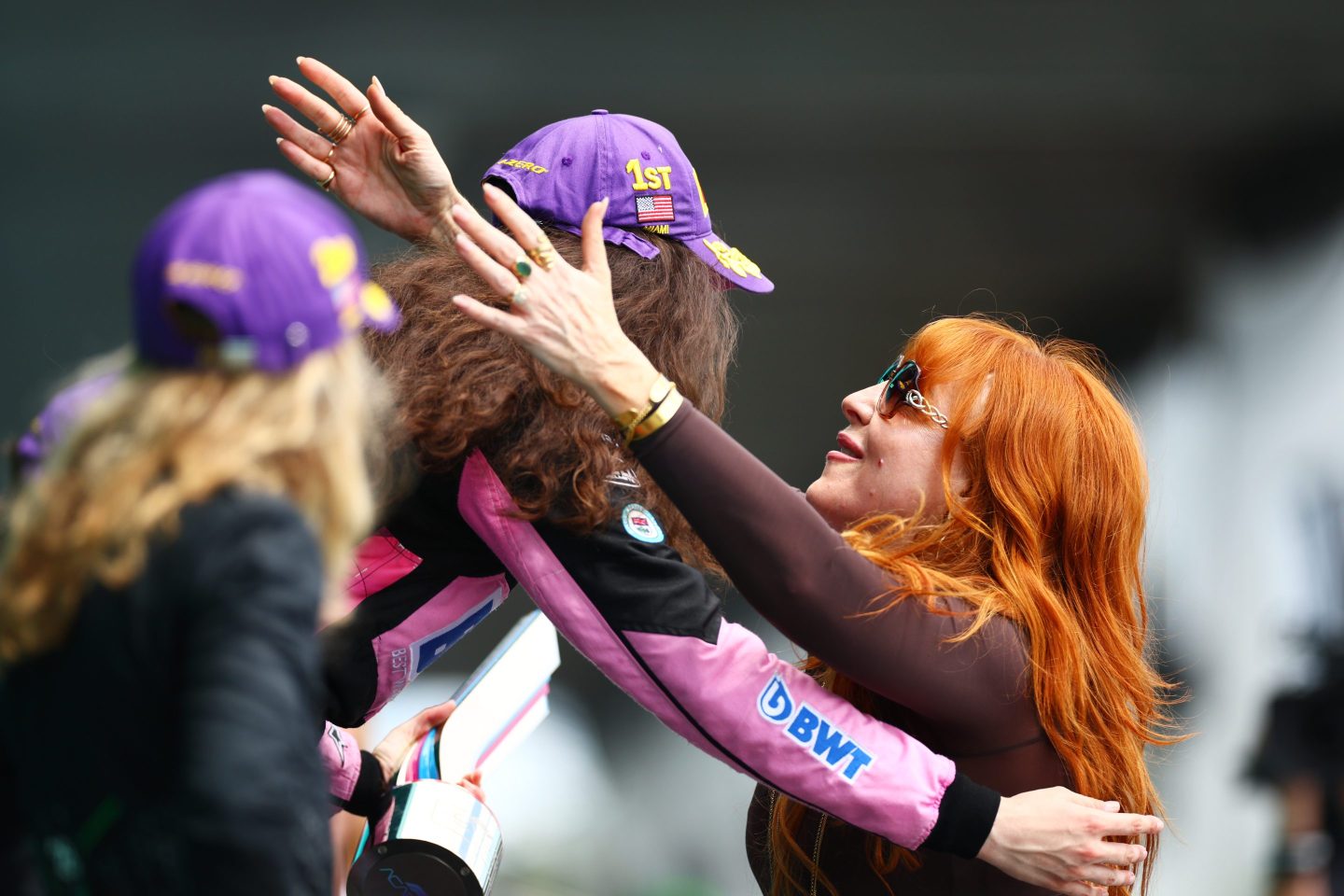 Charlotte Tilbury hugs a female race car driver.