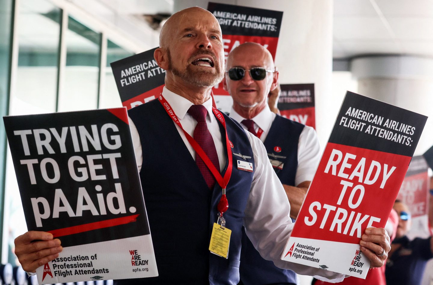 American Airlines flight attendants hold “ready to strike” signs