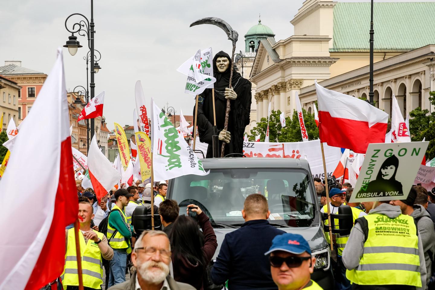 Protesters lead a model of the grim reaper as Solidarity organisation and Polish farmers protest with Polish and Solidarity flags and anti Green Deal banners at Royal Castle Square
