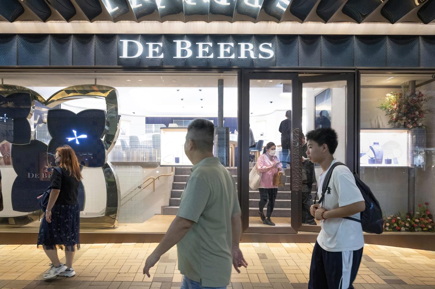 people walking outside a de beers store