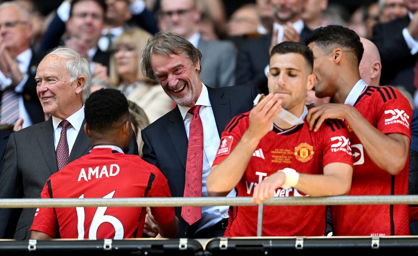 Jim Ratcliffe, minority owner of Manchester United shakes hands with Amad Diallo of Manchester United.
