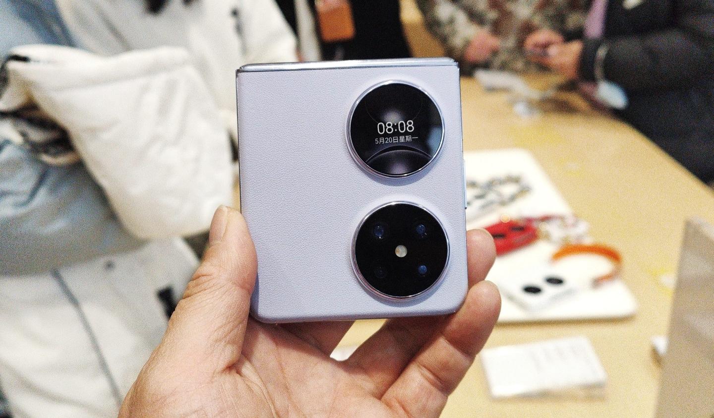 Customers buy Pocket 2, a flagship mobile phone with foldable screen, at a Huawei store in Shanghai, China, February 25, 2024.