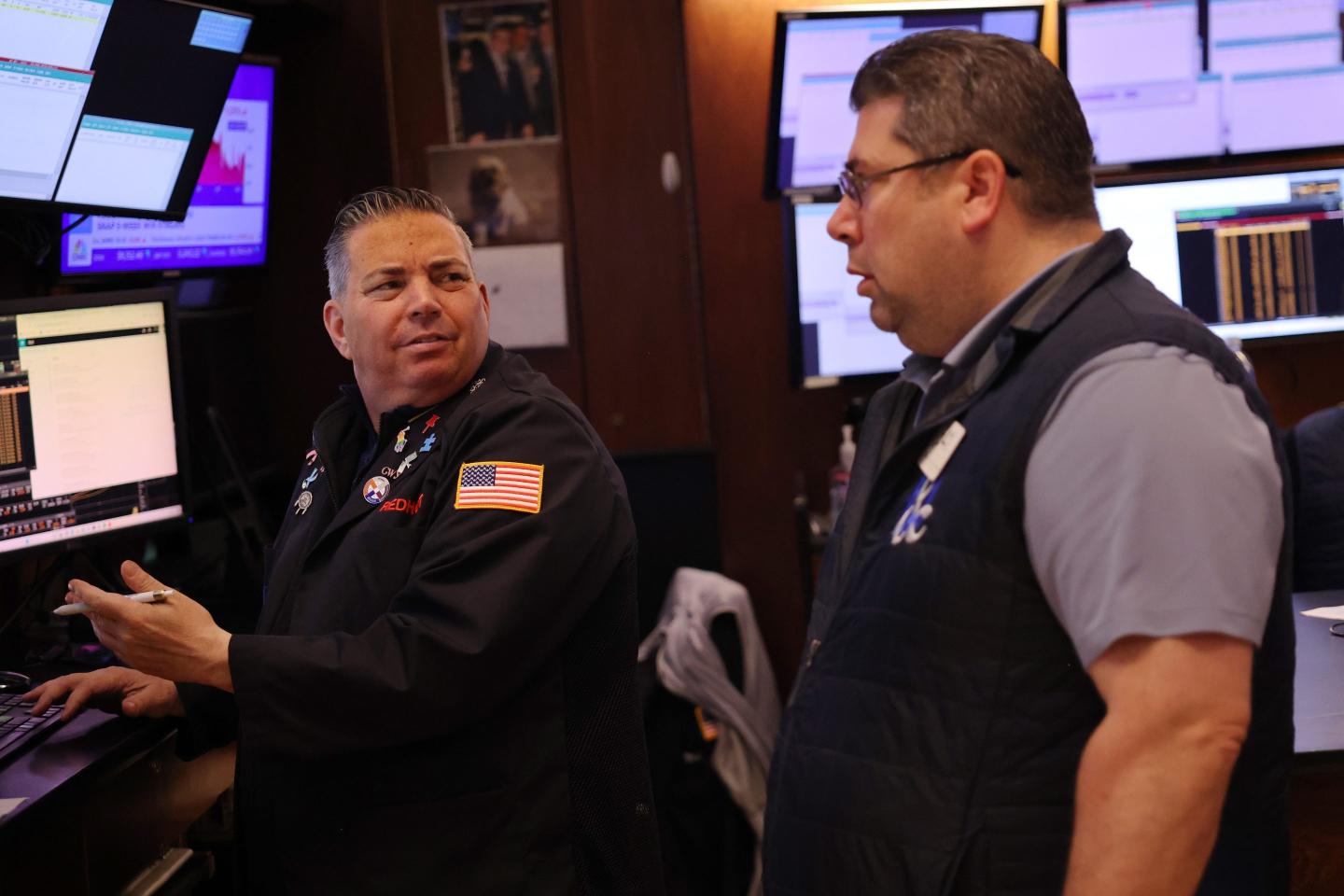 Two men look at each other on NYSE floor