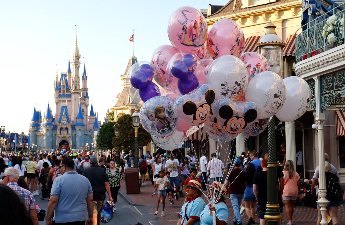 A vendor sells balloons along Main Street in front of Cinderella's Castle as the sun sets at the Magic Kingdom Park at Walt Disney World on May 31, 2024, in Orlando, Florida.