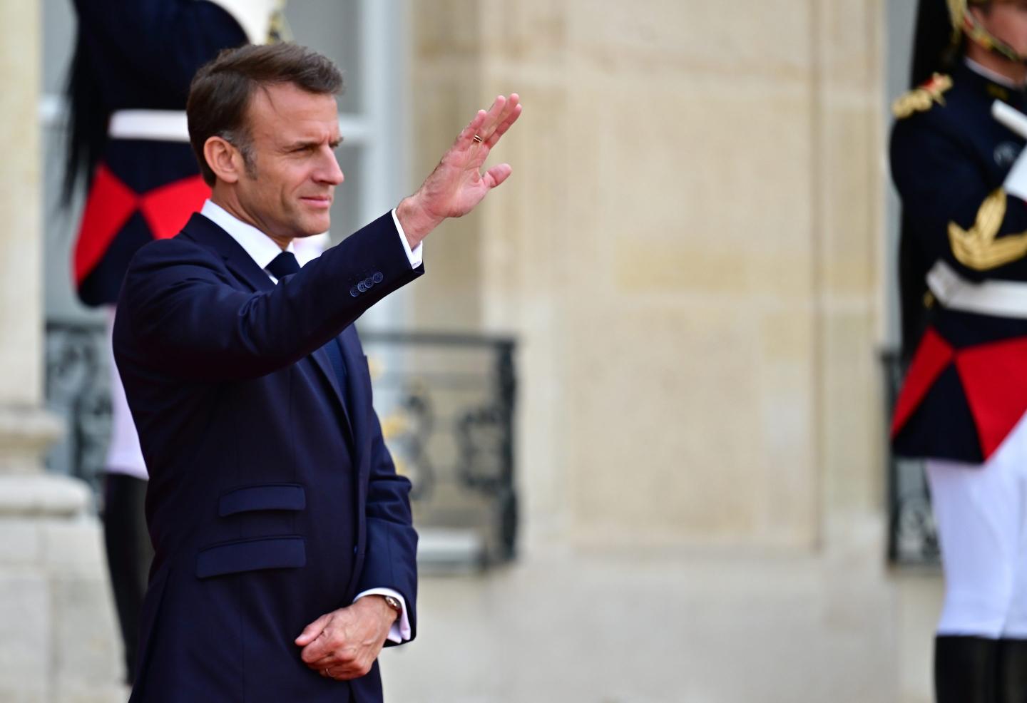 President Emmanuel Macron waving