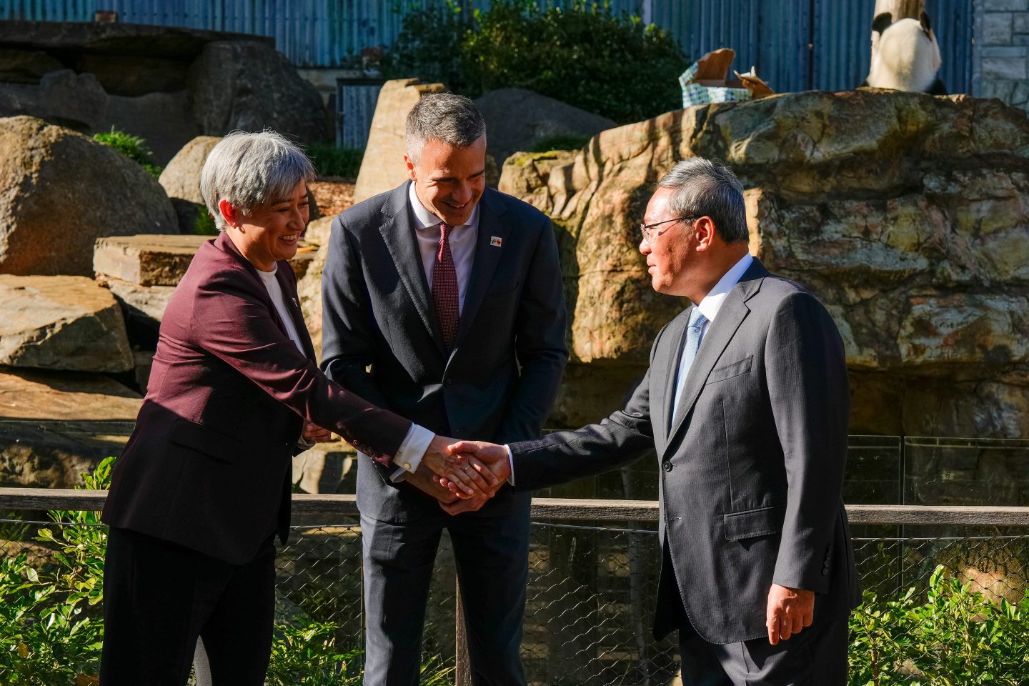Australia's foreign minister Penny Wong, left, shakes hands with China's premier Li Qiang at the Adelaide Zoo on June 16, 2024, as South Australian premier Peter Malinauskas looks on.