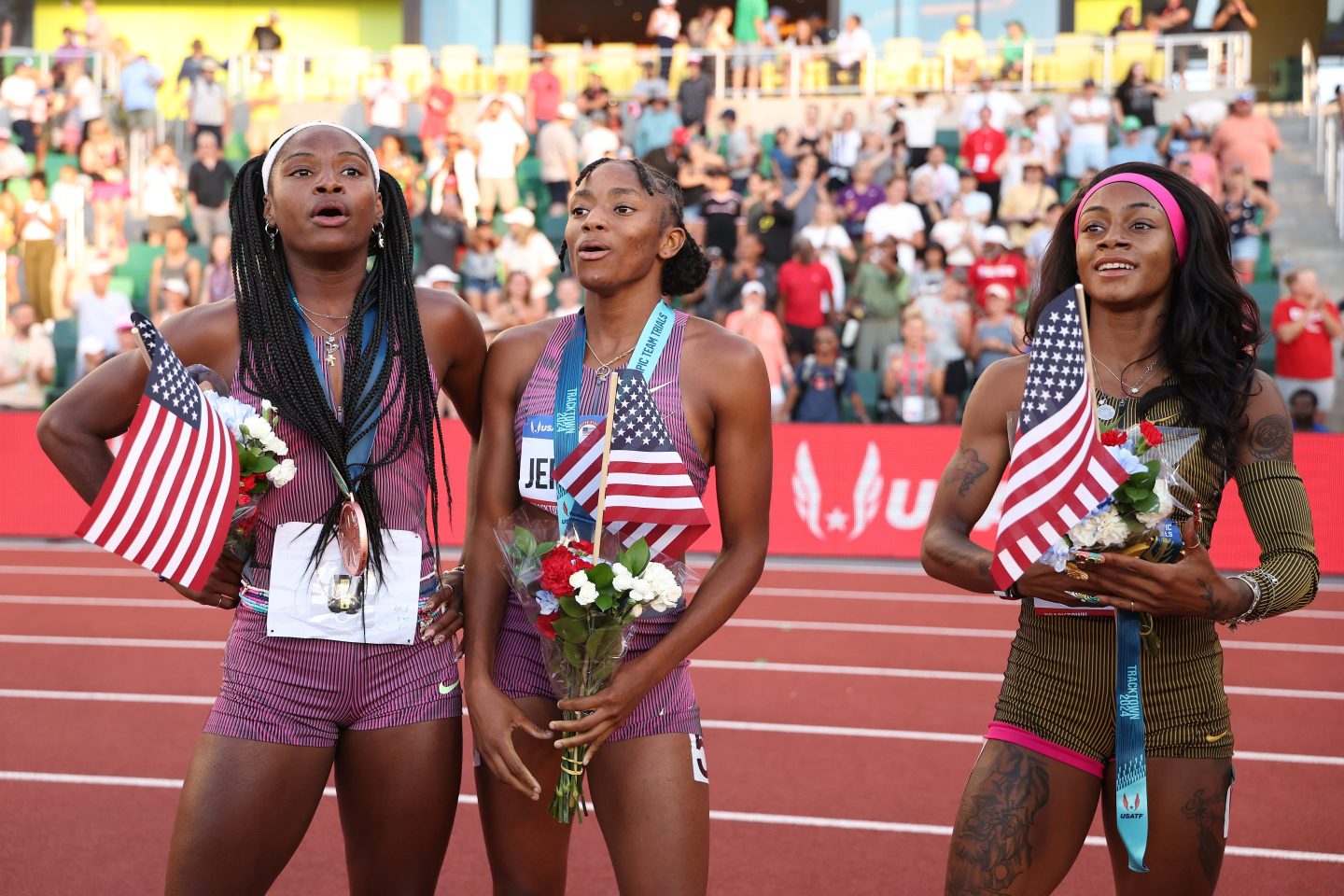US athletes hold American flags