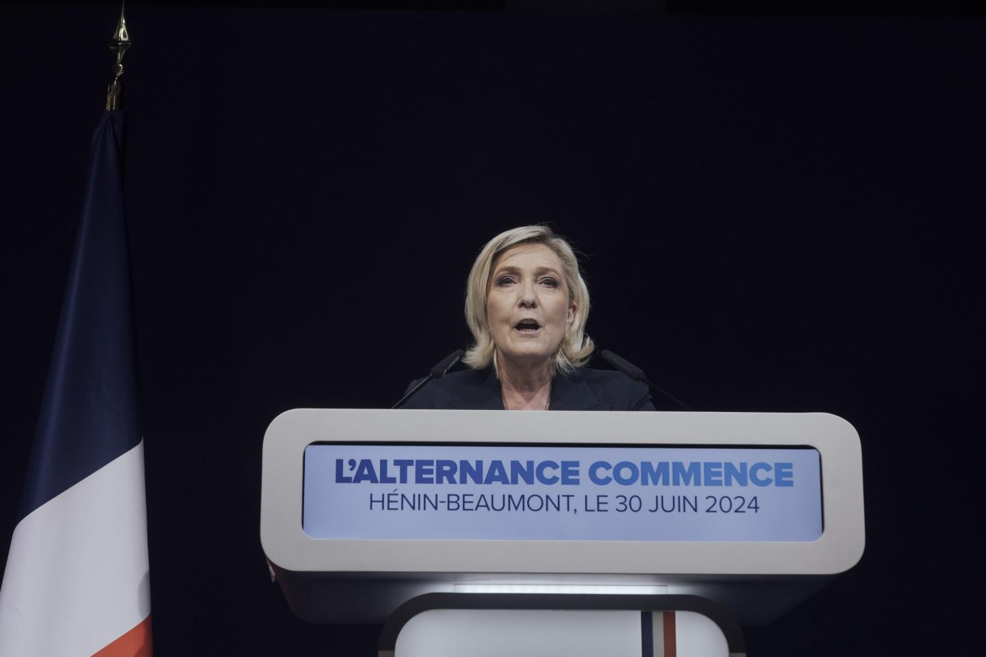 Marine Le Pen speaks at podium