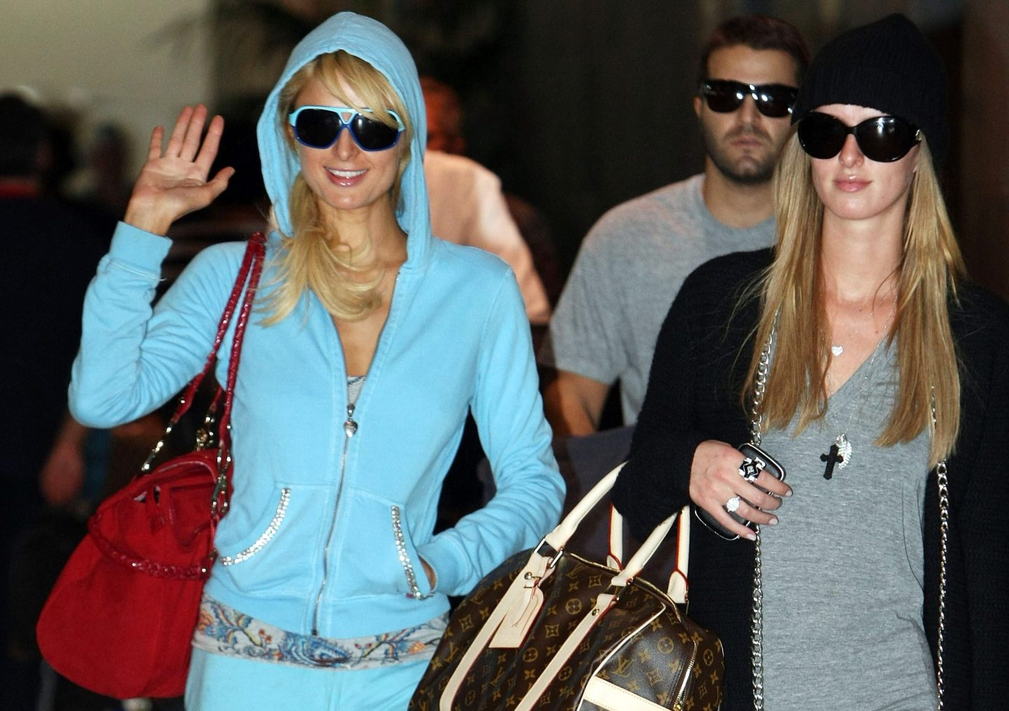 Socialite Paris Hilton waves as she arrives at Melbourne Airport on December 29, 2008