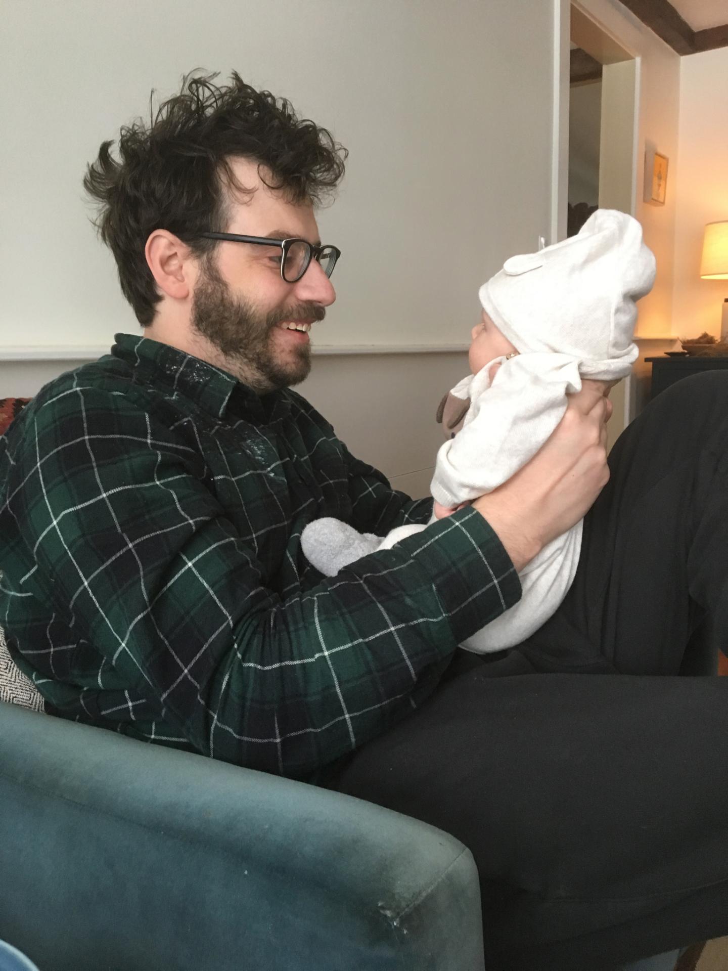 Photo of writer Peter Saalfield holding a newborn baby