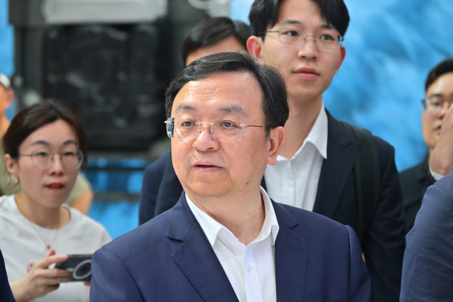Wang Chuanfu at an automotive event, surrounded by a crowd