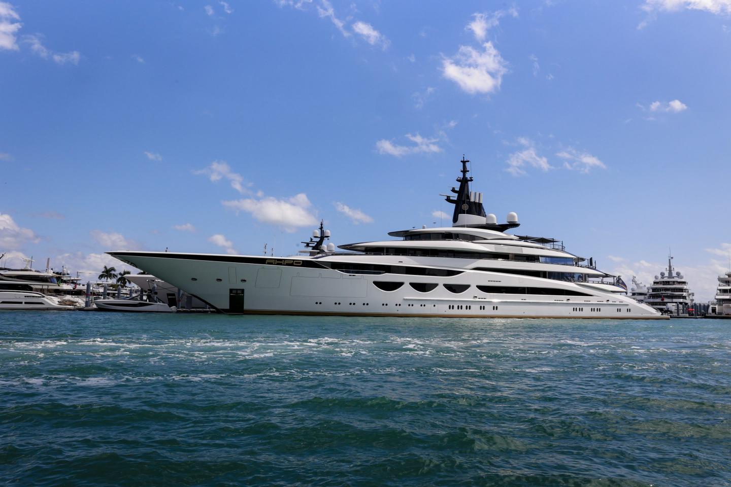 A superyacht moored, with a blue sky