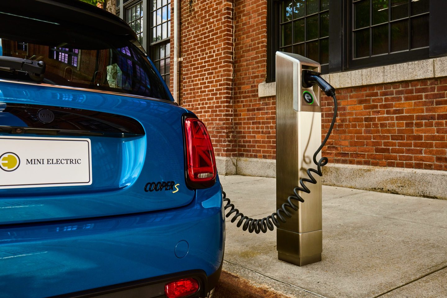Car plugged into curbside EV charger