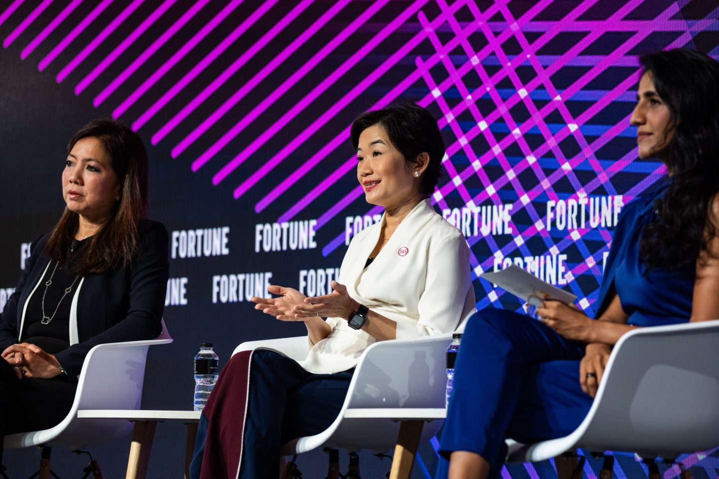 Su Shan Tan, head of institutional banking at DBS (left), and Jacqueline Poh, managing director of the Singapore Economic Development Board (center), speaking at Fortune Brainstorm AI Singapore.