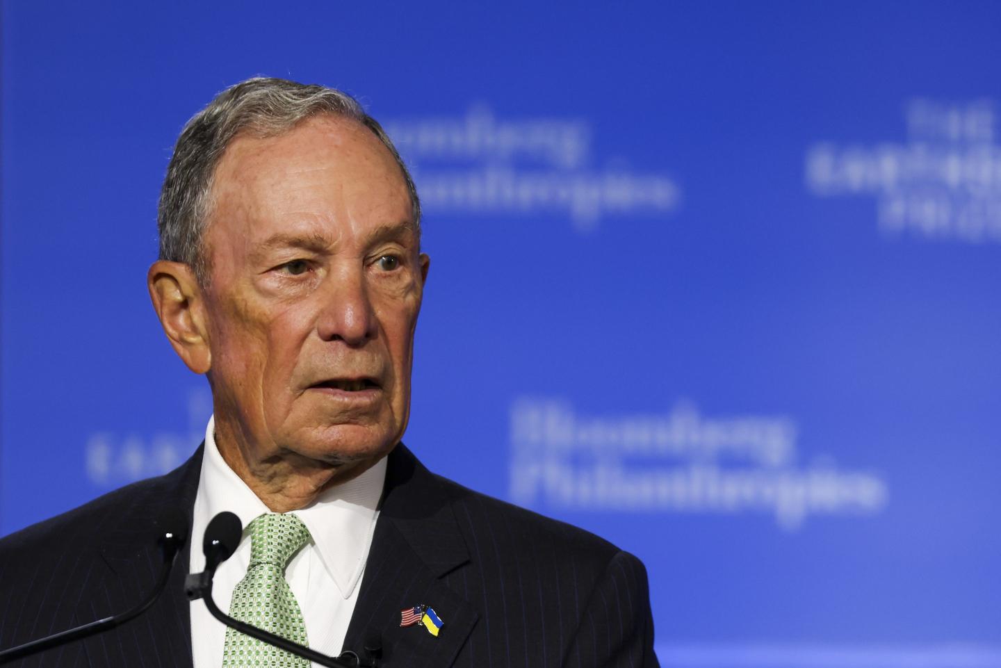 Michael Bloomberg in front of a microphone