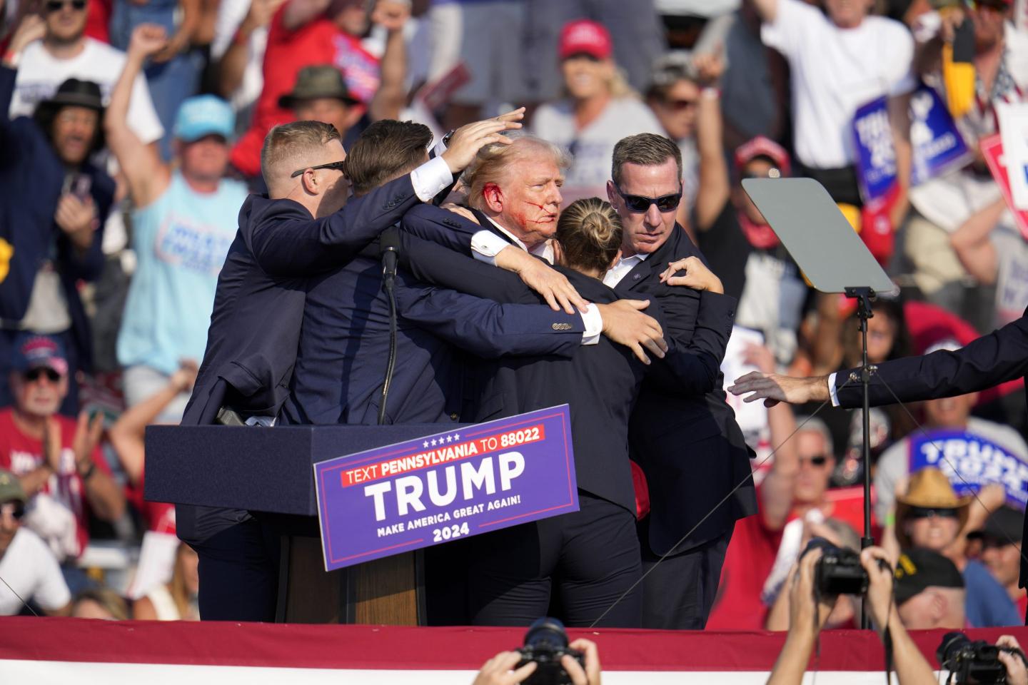Donald Trump is helped off stage