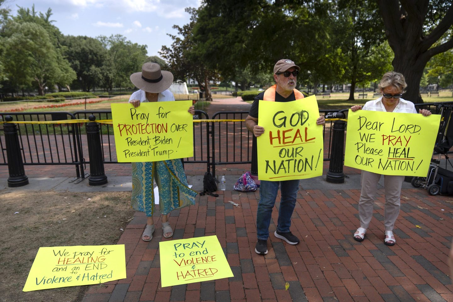 Activists pray for the safety of President Joe Biden, former President Donald Trump and other politicians at Lafayette Square near the White House, on July 14, 2024, in Washington, one day after an assassination attempt on Trump.
