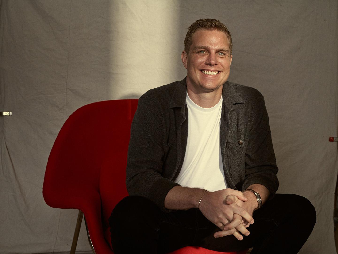 a man smiling, posing for a portrait