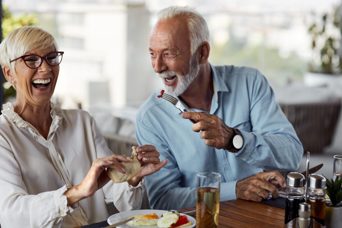 Couple Having Breakfast On The Hotel Rooftop Restaurant.
