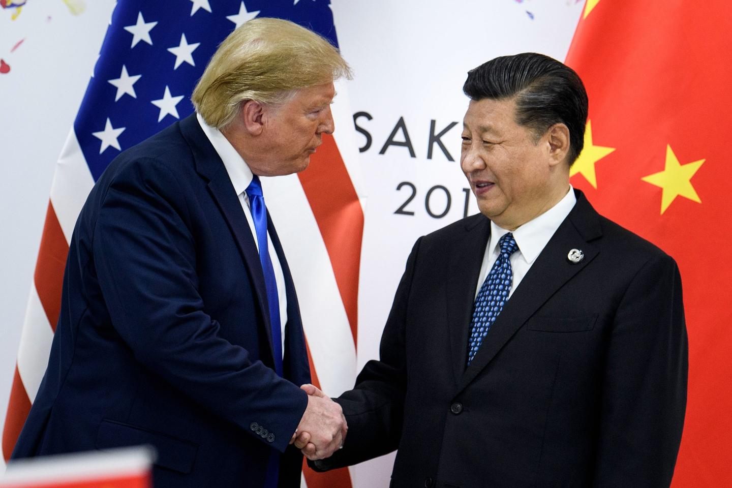 Donald Trump shakes hands with Xi Jinping