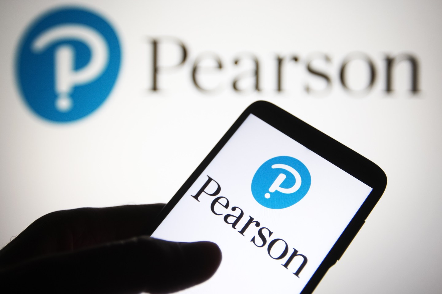 image of a mobile phone displaying the corporate logo of Pearson PLC