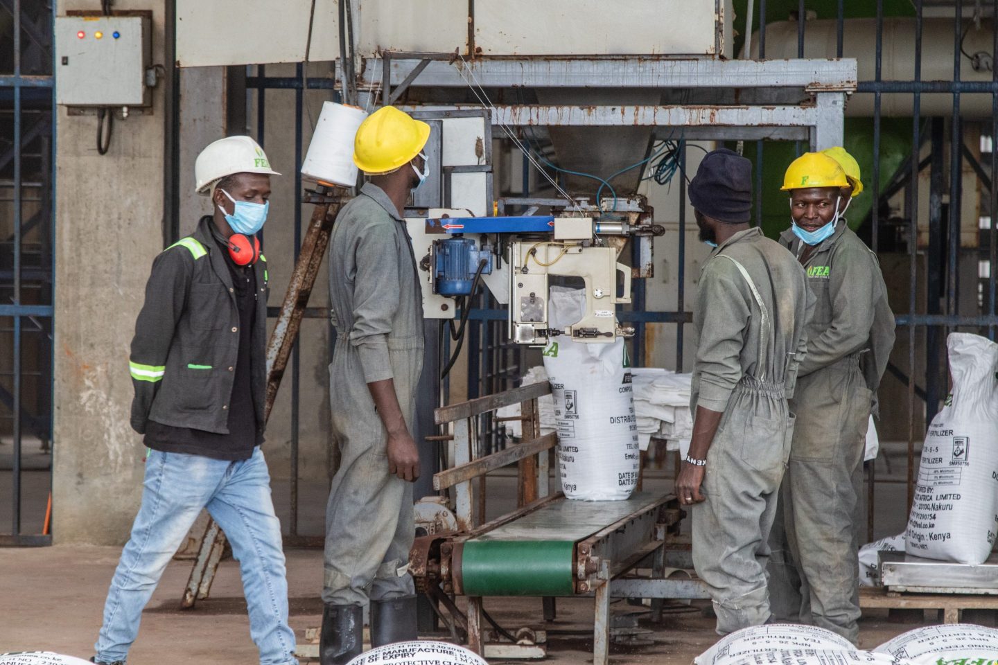 Workers operate a fertilizer packaging unit at the Fertiplant granulation Factory in Nakuru, Kenya on March 3, 2023.