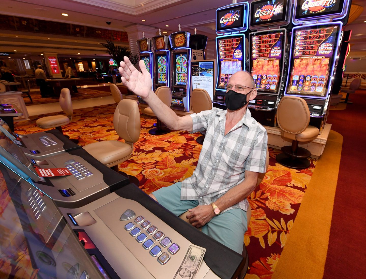 Man reacts at a slot machine