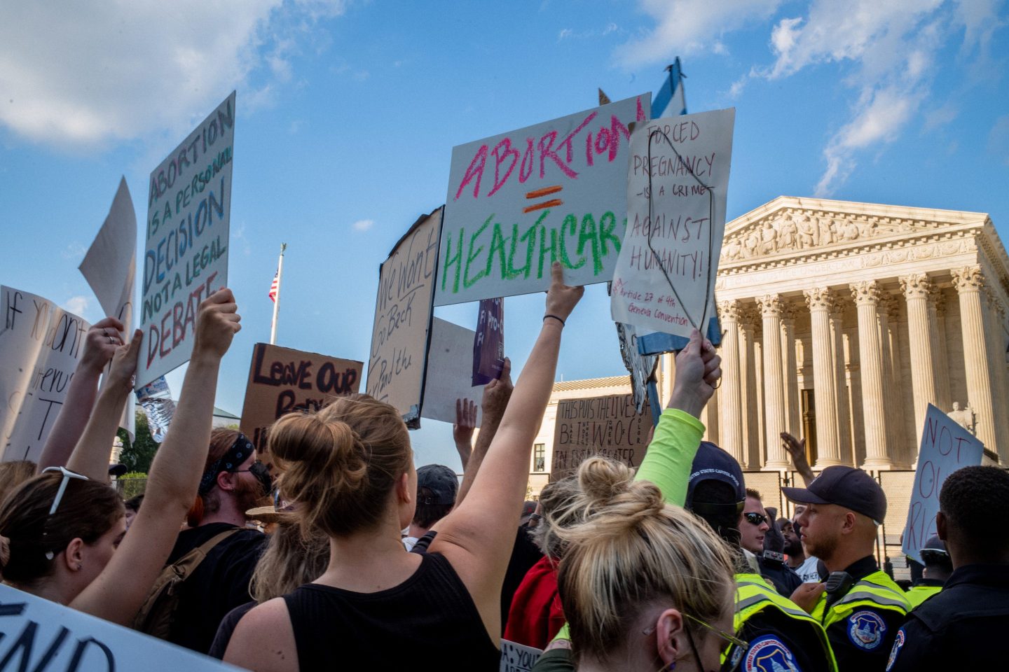 Demonstrators protest in front of the Supreme Court building following the announcement to the Dobbs v Jackson Women's Health Organization ruling on June 25, 2022 in Washington, DC. The Court's decision in the Dobbs v Jackson Women's Health case overturned the landmark 50-year-old Roe v Wade case, removing a federal right to an abortion.