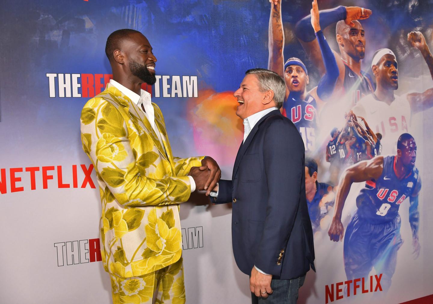 Netflix co-CEO Ted Sarandos shakes hands with former NBA player Dwyane Wade at a movie premier