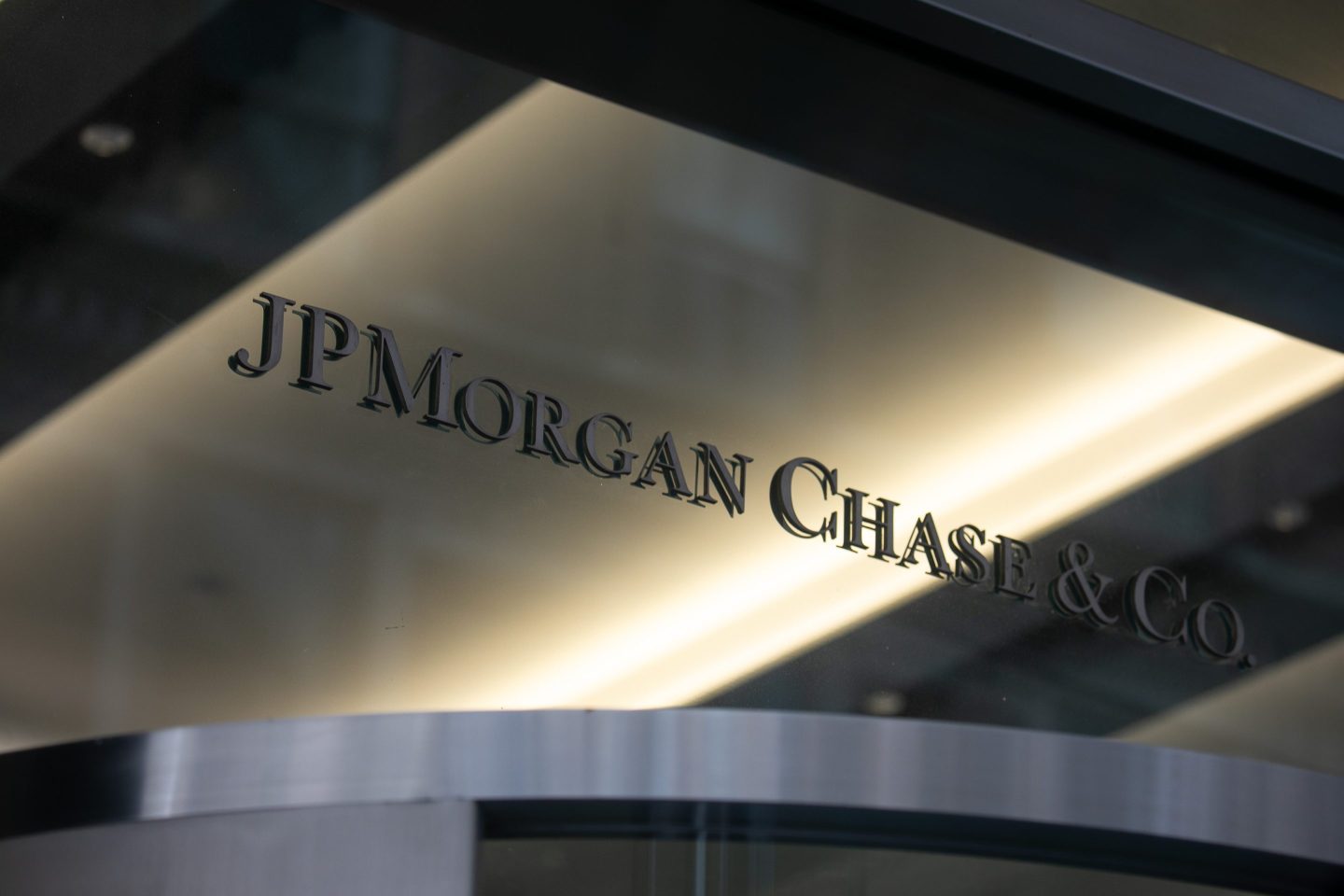 JPMorgan's logo on a reflective metallic and glass surface