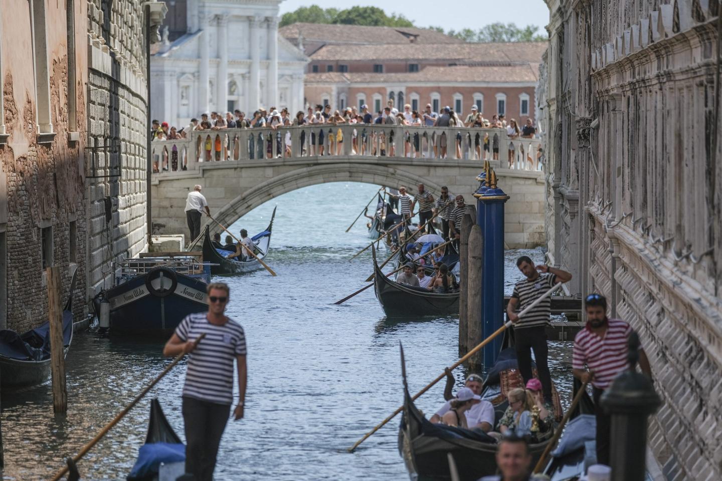 people on gondolas in one of Venice's canals