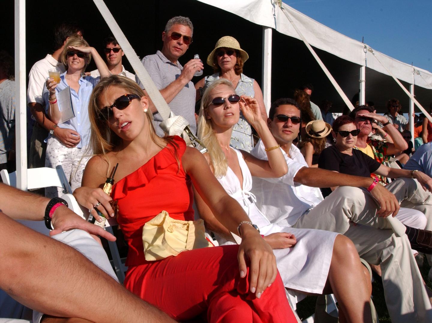 Spectators watch the Mercedes-Benz Polo Challenge July 21, 2001 in Bridgehampton, NY. The Hamptons, located at the east end of New York''s Long Island, is a traditional summer escape for New Yorkers.