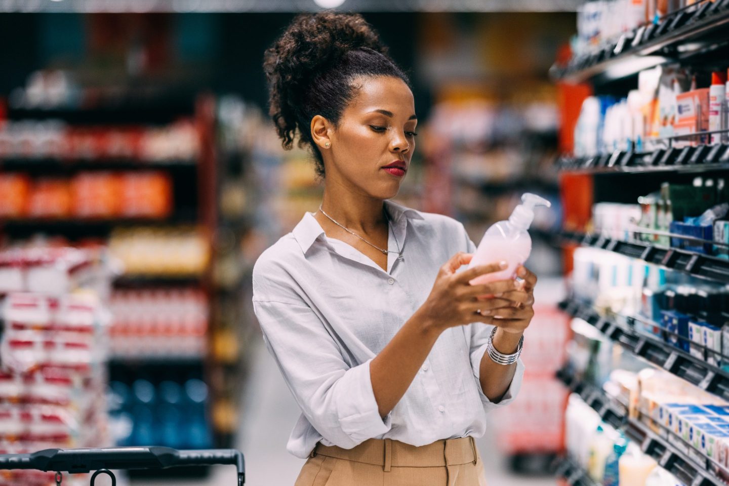 Woman looking at product in store aisle