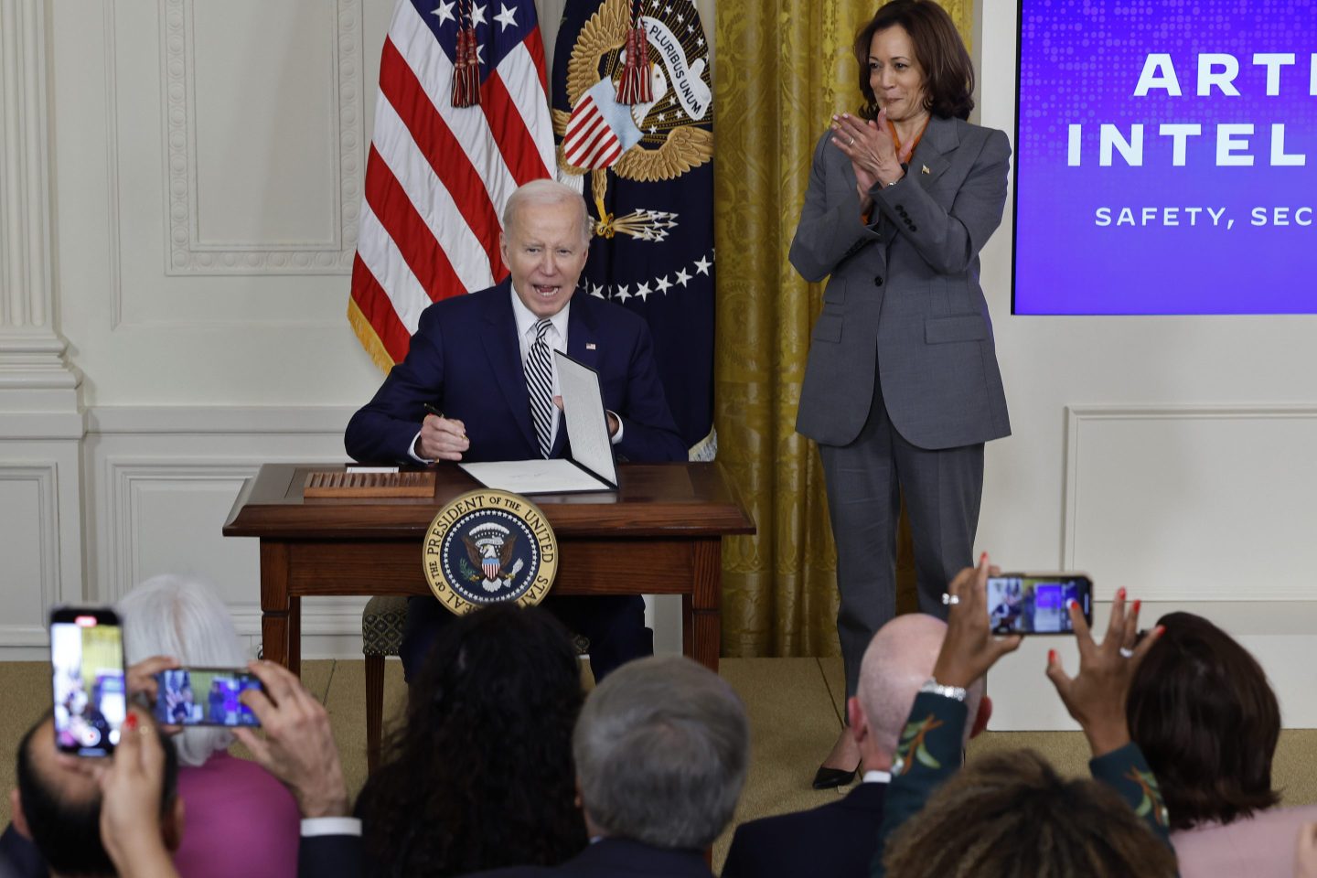 U.S. Vice President Kamala Harris (R) looks on as President Joe Biden signs a new executive order guiding his administration's approach to artificial intelligence during an event in the East Room of the White House on Oct. 30, 2023 in Washington, DC.