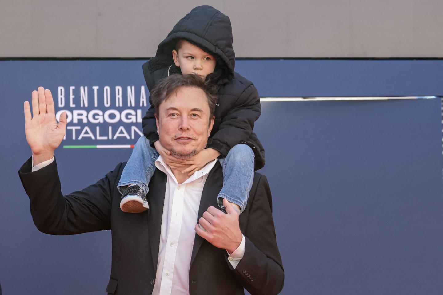 Elon Musk, chief executive officer of Tesla Inc., and his son arrive at the Atreju convention in Rome, Italy, on Saturday, Dec. 16, 2023.