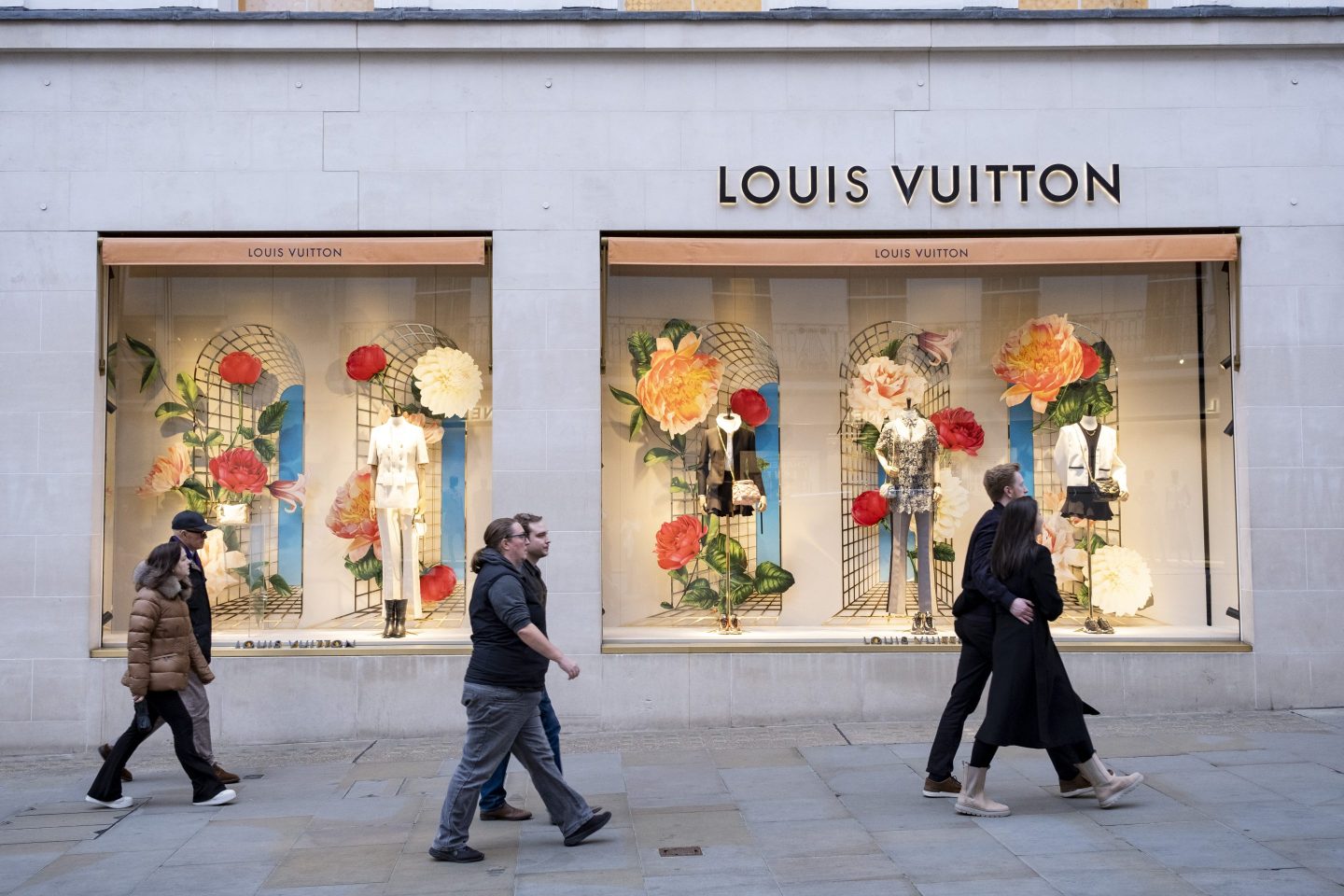 People passing the Louis Vuitton store on Bond Street which has seen a recent drop in demand for luxury goods and with some stores deciding to move out on 4th February 2024 in London, United Kingdom. Bond Street is one of the principal streets in the West End shopping district and is very upmarket and has been a fashionable shopping street since the 18th century. The rich and wealthy shop here mostly for high end fashion and jewellery. (photo by Mike Kemp/In Pictures via Getty Images)