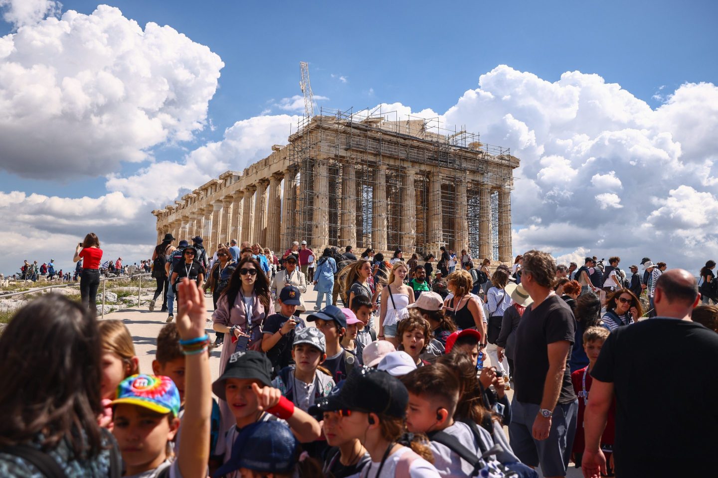 crowds of people standing near the Parthenon