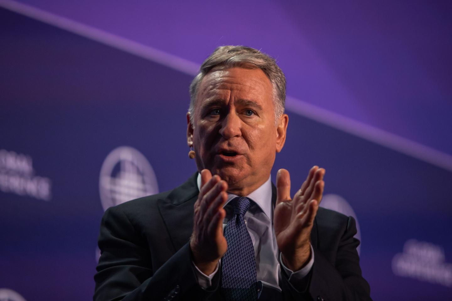 Ken Griffin holds hands out
